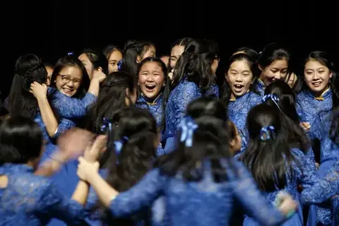 Choir in blue performing in harmony