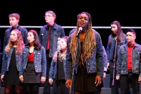 Soloist performing with a choir at the World Choir Games