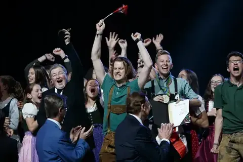 Choir celebrating on stage at the World Choir Games