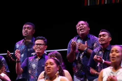 Choir in traditional folklore costumes on stage